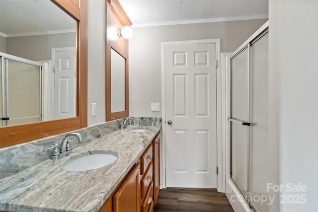 2021 Beamguard Rd, Clover, SC 29710 - bathroom featuring crown molding, double vanity, a shower with shower door, and wood finished floors