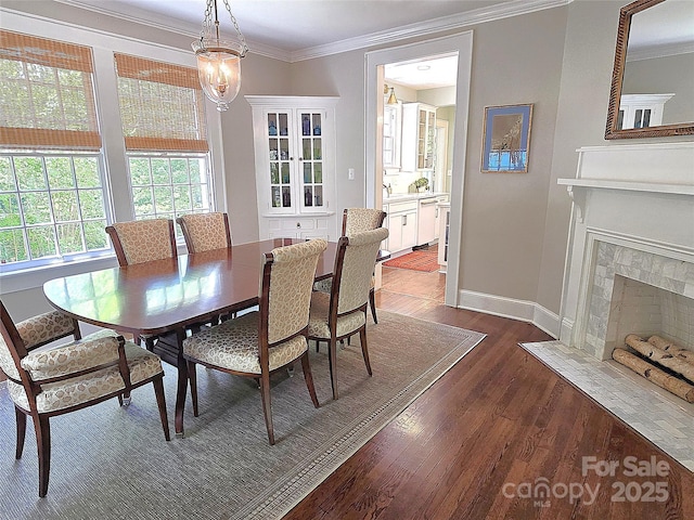 1051 14th Avenue Dr NW, Hickory, NC 28601 - dining area featuring crown molding, dark wood finished floors, baseboards, and a fireplace