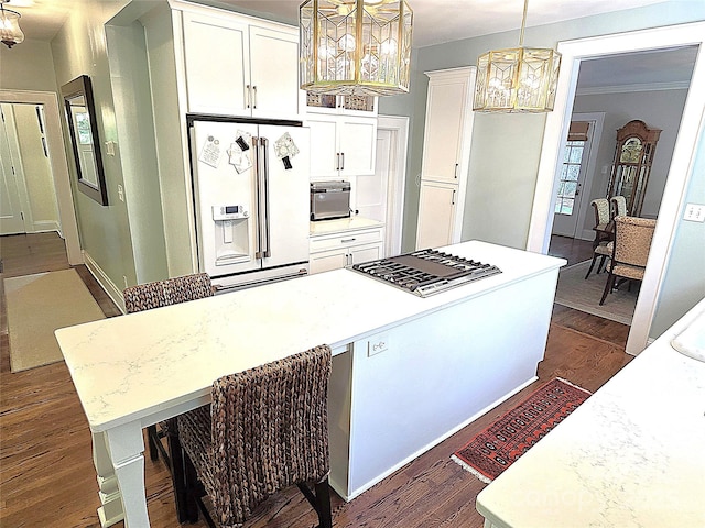 1051 14th Avenue Dr NW, Hickory, NC 28601 - kitchen with white refrigerator with ice dispenser, a chandelier, stainless steel gas cooktop, dark wood-style floors, and ornamental molding