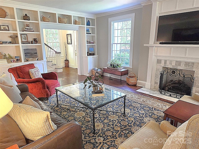 1051 14th Avenue Dr NW, Hickory, NC 28601 - living area with wood finished floors, healthy amount of natural light, built in shelves, ornamental molding, and baseboards