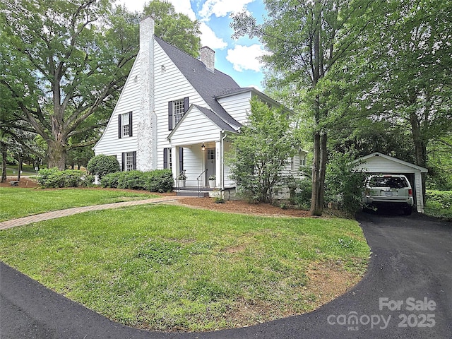 1051 14th Avenue Dr NW, Hickory, NC 28601 - view of front facade with a front yard, a chimney, an outdoor structure, a garage, and asphalt driveway