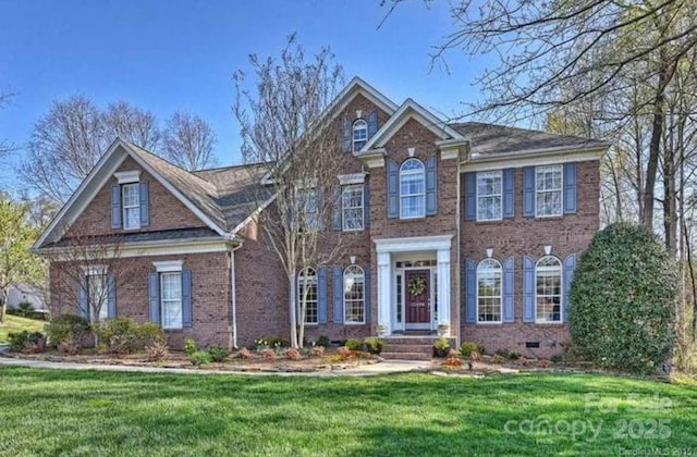 15494 Donnington Dr, Charlotte, NC 28277 - colonial inspired home with brick siding and a front lawn