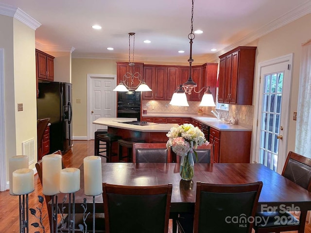 15494 Donnington Dr, Charlotte, NC 28277 - dining room with wood finished floors, recessed lighting, ornamental molding, and baseboards