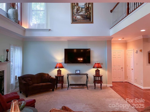 15494 Donnington Dr, Charlotte, NC 28277 - carpeted living room featuring a high ceiling, baseboards, a high end fireplace, recessed lighting, and crown molding