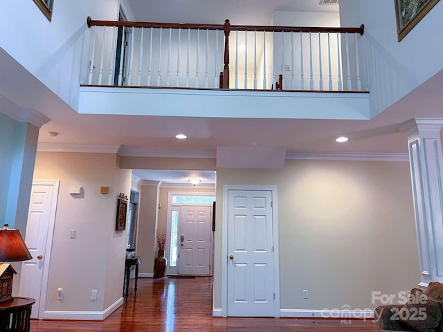 15494 Donnington Dr, Charlotte, NC 28277 - foyer featuring a towering ceiling, wood finished floors, ornamental molding, recessed lighting, and baseboards