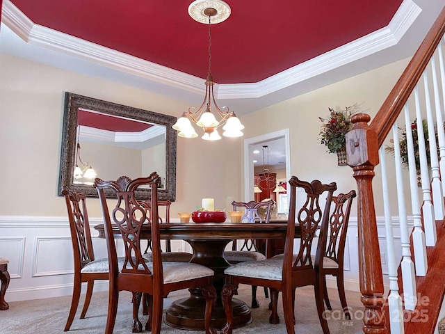 15494 Donnington Dr, Charlotte, NC 28277 - dining room with crown molding, carpet flooring, a chandelier, a wainscoted wall, and stairs