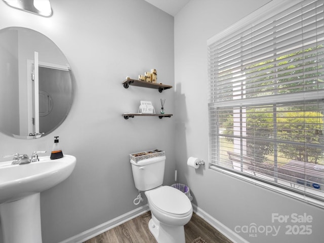 10426 Kempsford Dr, Charlotte, NC 28262 - bathroom featuring toilet, wood finished floors, a sink, and baseboards