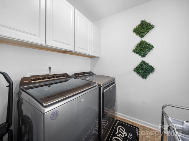 10426 Kempsford Dr, Charlotte, NC 28262 - washroom featuring washing machine and clothes dryer, cabinet space, baseboards, and wood finished floors