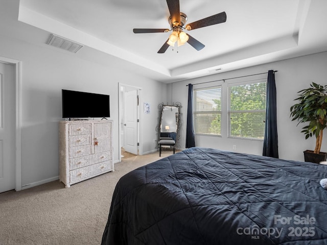 10426 Kempsford Dr, Charlotte, NC 28262 - bedroom with a tray ceiling, carpet flooring, baseboards, and ceiling fan