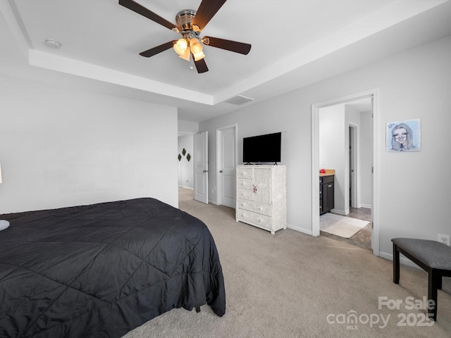 10426 Kempsford Dr, Charlotte, NC 28262 - bedroom with light colored carpet, a tray ceiling, baseboards, and ceiling fan