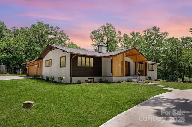 5033 Waxhaw Indian Trail Rd, Matthews, NC 28104 - view of front facade featuring concrete driveway, a garage, a lawn, and a chimney