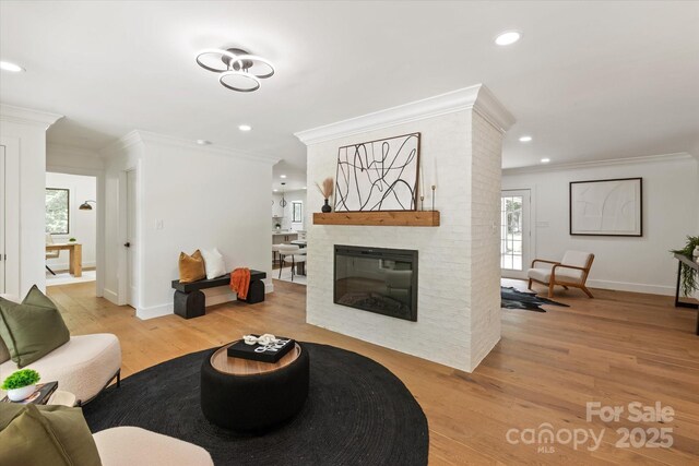 5033 Waxhaw Indian Trail Rd, Matthews, NC 28104 - living area featuring ornamental molding, light wood finished floors, plenty of natural light, recessed lighting, and baseboards