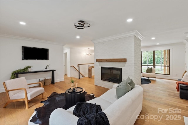 5033 Waxhaw Indian Trail Rd, Matthews, NC 28104 - living area featuring crown molding, wood finished floors, recessed lighting, baseboards, and a fireplace