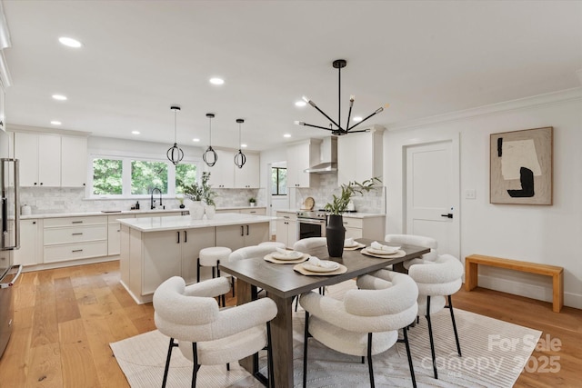 5033 Waxhaw Indian Trail Rd, Matthews, NC 28104 - dining space featuring a chandelier, recessed lighting, light wood-style floors, and crown molding