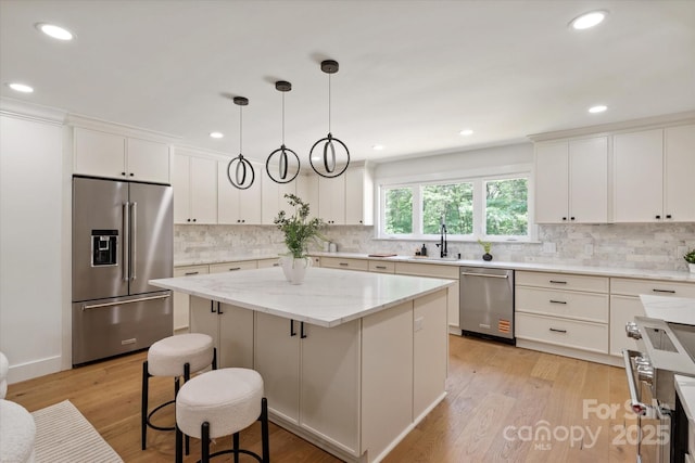 5033 Waxhaw Indian Trail Rd, Matthews, NC 28104 - kitchen with premium appliances, a center island, a kitchen bar, tasteful backsplash, and recessed lighting