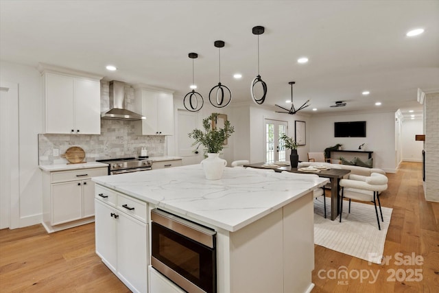 5033 Waxhaw Indian Trail Rd, Matthews, NC 28104 - kitchen with wall chimney exhaust hood, appliances with stainless steel finishes, a kitchen island, recessed lighting, and decorative backsplash