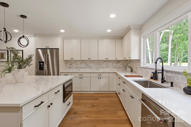 5033 Waxhaw Indian Trail Rd, Matthews, NC 28104 - kitchen featuring appliances with stainless steel finishes, a sink, recessed lighting, backsplash, and light stone counters