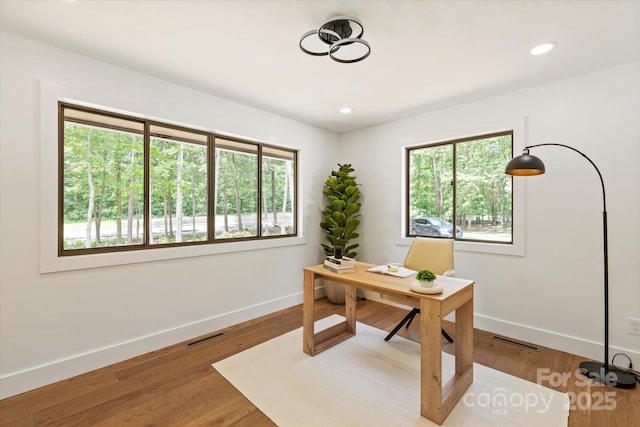 5033 Waxhaw Indian Trail Rd, Matthews, NC 28104 - home office featuring plenty of natural light, baseboards, wood finished floors, and recessed lighting