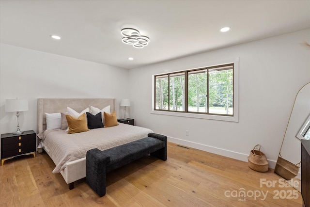 5033 Waxhaw Indian Trail Rd, Matthews, NC 28104 - bedroom with multiple windows, baseboards, light wood-type flooring, and recessed lighting