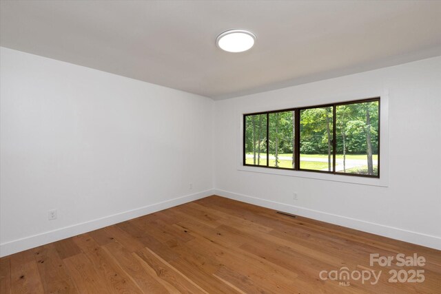 5033 Waxhaw Indian Trail Rd, Matthews, NC 28104 - unfurnished room featuring baseboards and wood finished floors