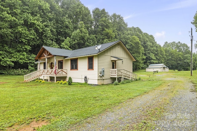 3540 Fork Creek Rd, Saluda, NC 28773 - view of front of property featuring driveway, a front lawn, roof with shingles, covered porch, and board and batten siding