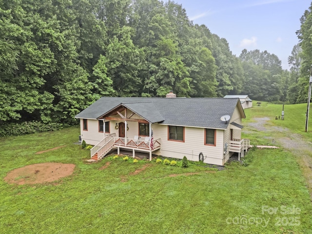 3540 Fork Creek Rd, Saluda, NC 28773 - view of front of property featuring covered porch, a front yard, a chimney, and roof with shingles