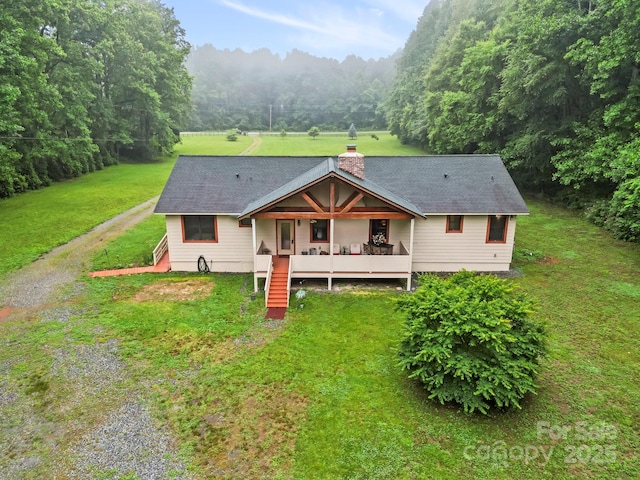 3540 Fork Creek Rd, Saluda, NC 28773 - view of front of property with a front yard, a chimney, a forest view, roof with shingles, and stairs