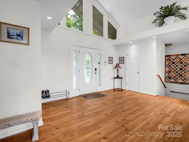 698 Youngs Mountain Dr, Lake Lure, NC 28746 - entrance foyer with light wood finished floors, a towering ceiling, and recessed lighting