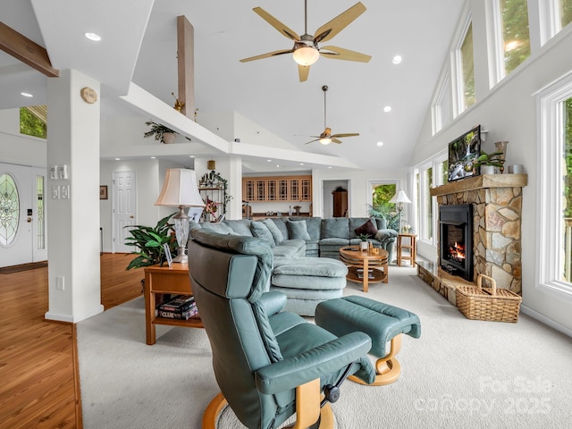 698 Youngs Mountain Dr, Lake Lure, NC 28746 - living area with high vaulted ceiling, a ceiling fan, recessed lighting, a stone fireplace, and plenty of natural light