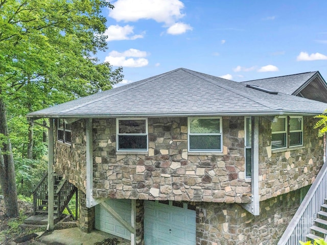 698 Youngs Mountain Dr, Lake Lure, NC 28746 - view of side of property featuring stairway, stone siding, a shingled roof, and a garage