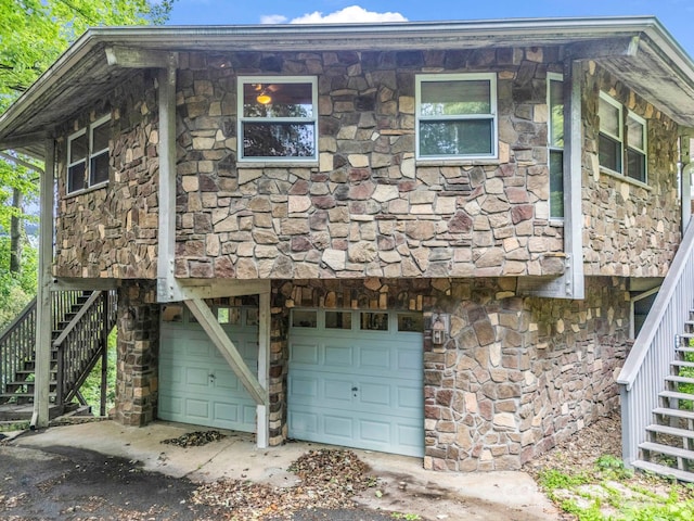 698 Youngs Mountain Dr, Lake Lure, NC 28746 - view of home's exterior featuring stairs, an attached garage, stone siding, and driveway