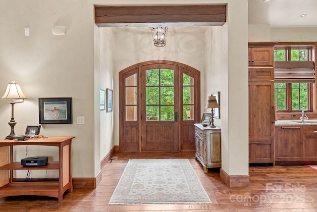 577 Walnut Valley Pkwy, Arden, NC 28704 - entryway featuring hardwood / wood-style floors, baseboards, a chandelier, and arched walkways