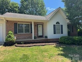 2669 Icard Rhodhiss Rd, Connelly Springs, NC 28612 - ranch-style home with covered porch, a front lawn, brick siding, and a garage