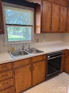 2669 Icard Rhodhiss Rd, Connelly Springs, NC 28612 - kitchen featuring a sink, light countertops, oven, brown cabinetry, and light flooring