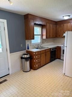 2669 Icard Rhodhiss Rd, Connelly Springs, NC 28612 - kitchen with light countertops, light flooring, freestanding refrigerator, range, and dishwasher