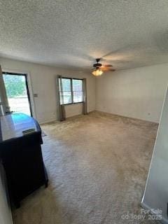 2669 Icard Rhodhiss Rd, Connelly Springs, NC 28612 - unfurnished living room featuring carpet floors, a textured ceiling, and a ceiling fan
