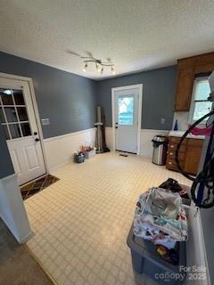2669 Icard Rhodhiss Rd, Connelly Springs, NC 28612 - kitchen featuring a wainscoted wall, carpet flooring, rail lighting, and a chandelier