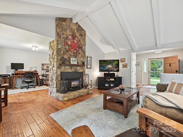 2911 Butter Churn Ln, Matthews, NC 28105 - living area with wood finished floors, beam ceiling, a wood stove, an office area, and high vaulted ceiling