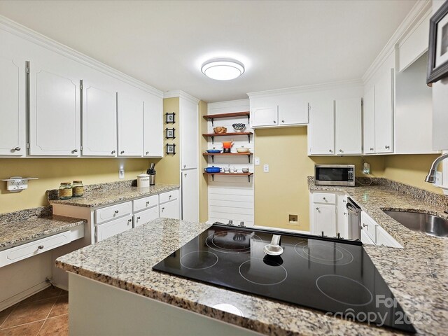 2911 Butter Churn Ln, Matthews, NC 28105 - kitchen with appliances with stainless steel finishes, a sink, white cabinetry, tile patterned floors, and light stone countertops