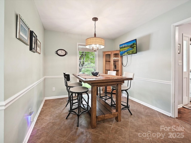 2911 Butter Churn Ln, Matthews, NC 28105 - dining room with dark tile patterned flooring, a chandelier, and baseboards