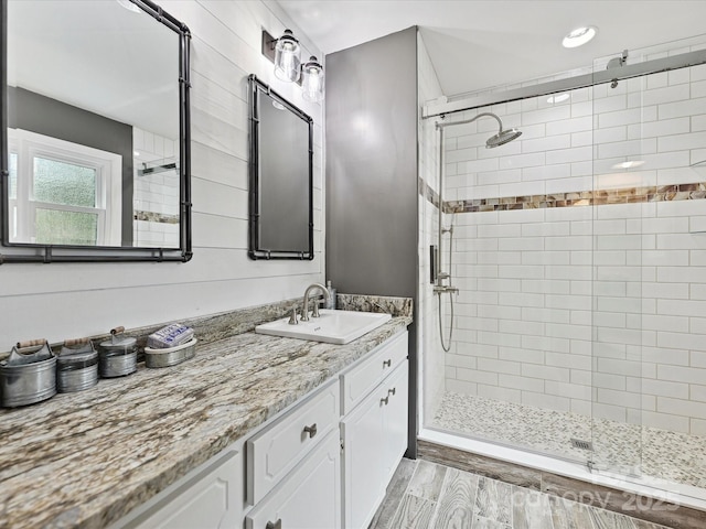 2911 Butter Churn Ln, Matthews, NC 28105 - bathroom featuring a stall shower, vanity, wood finished floors, and recessed lighting