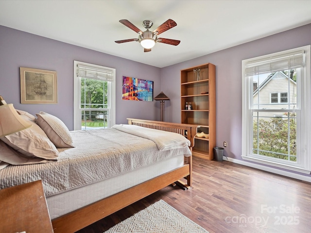 2911 Butter Churn Ln, Matthews, NC 28105 - bedroom with wood finished floors, baseboards, and ceiling fan