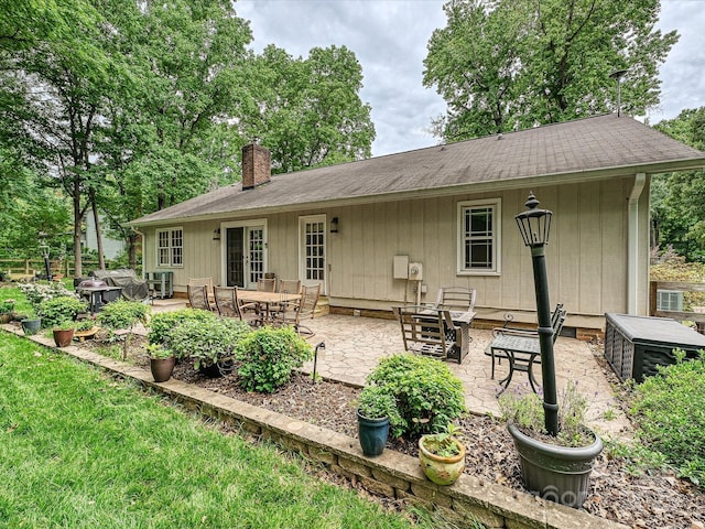 2911 Butter Churn Ln, Matthews, NC 28105 - back of property featuring a chimney and a patio