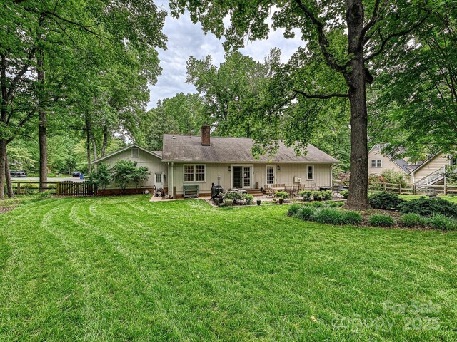 2911 Butter Churn Ln, Matthews, NC 28105 - rear view of property featuring a chimney, a patio area, roof with shingles, and central AC