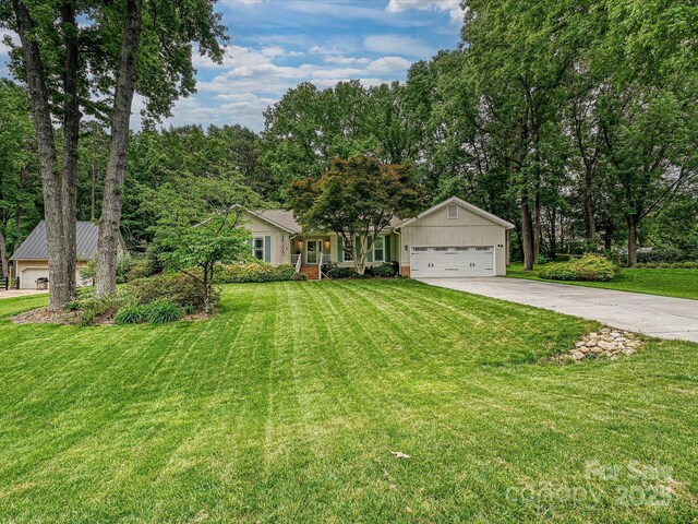 2911 Butter Churn Ln, Matthews, NC 28105 - ranch-style house with driveway, a garage, and a front lawn