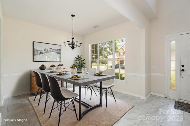 2013 Arbor Crest Ct, Charlotte, NC 28262 - dining space featuring a chandelier and baseboards