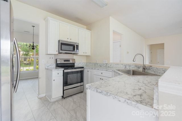 2013 Arbor Crest Ct, Charlotte, NC 28262 - kitchen featuring appliances with stainless steel finishes, a sink, white cabinetry, and light marble finish floors