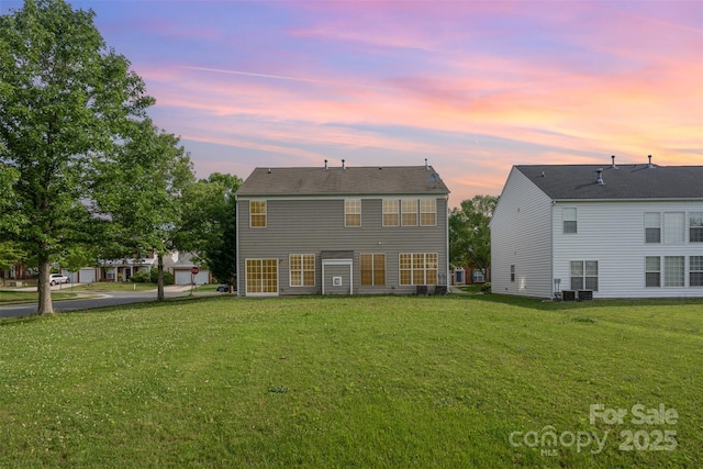 2013 Arbor Crest Ct, Charlotte, NC 28262 - back of house at dusk with a yard and central AC