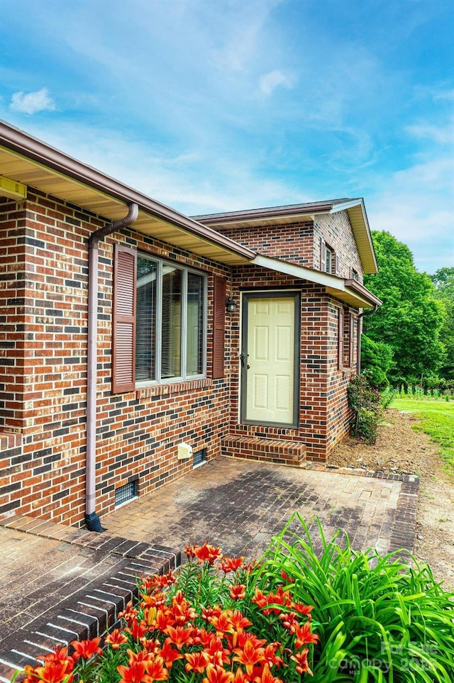 3020 Doc Pugh Rd, Connelly Springs, NC 28612 - view of exterior entry featuring brick siding and a patio area