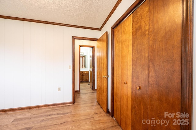 3020 Doc Pugh Rd, Connelly Springs, NC 28612 - hallway with light wood-style floors, a textured ceiling, baseboards, and ornamental molding